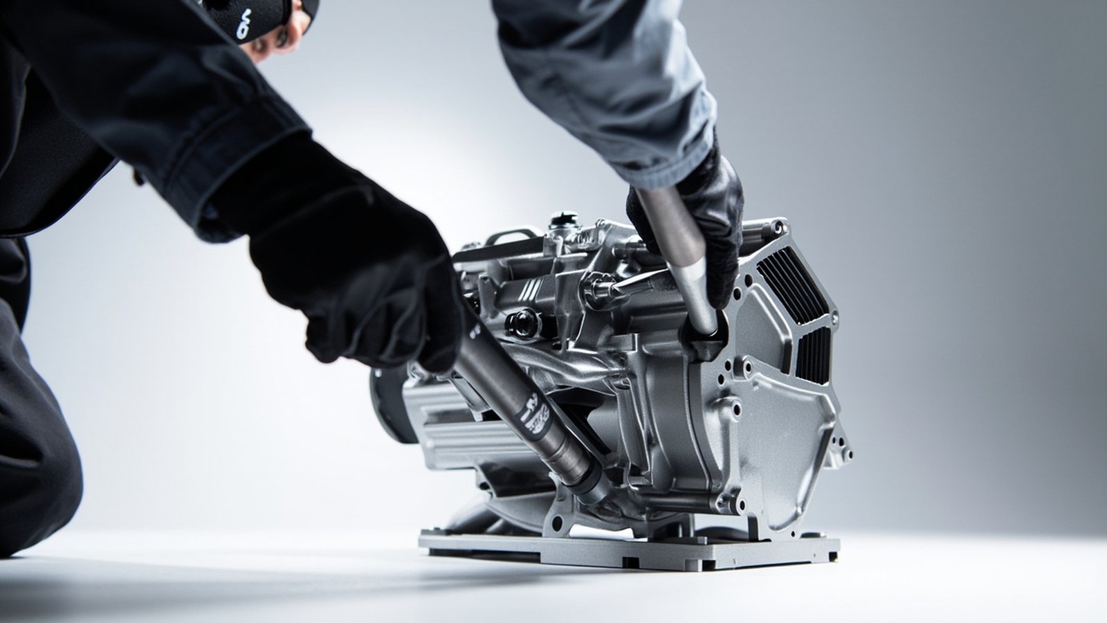 Engineers assembling a gearbox casing on a workbench